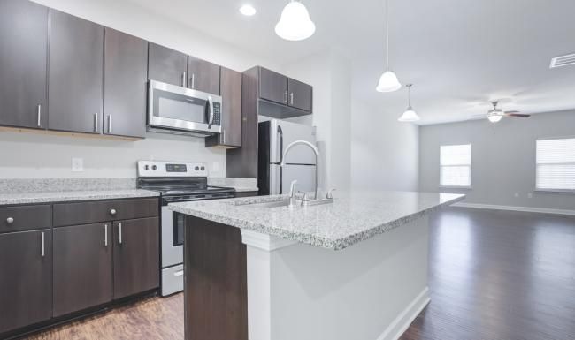 a kitchen with brown cabinets