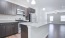 a kitchen with brown cabinets