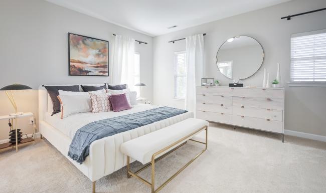 a bedroom with a bed and a mirror