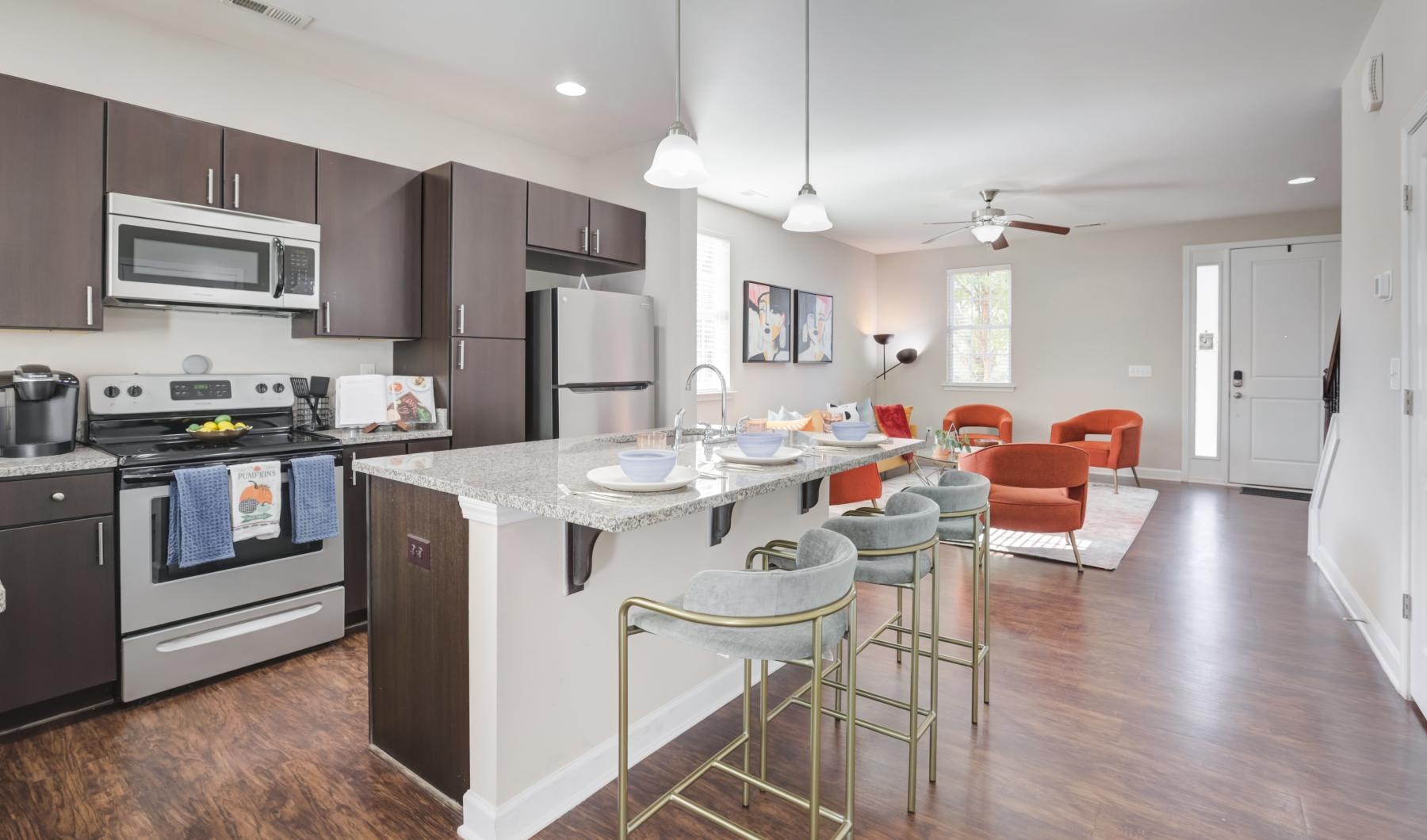 Open-concept living space with kitchen at Charleston Row townhomes for rent in Charlotte