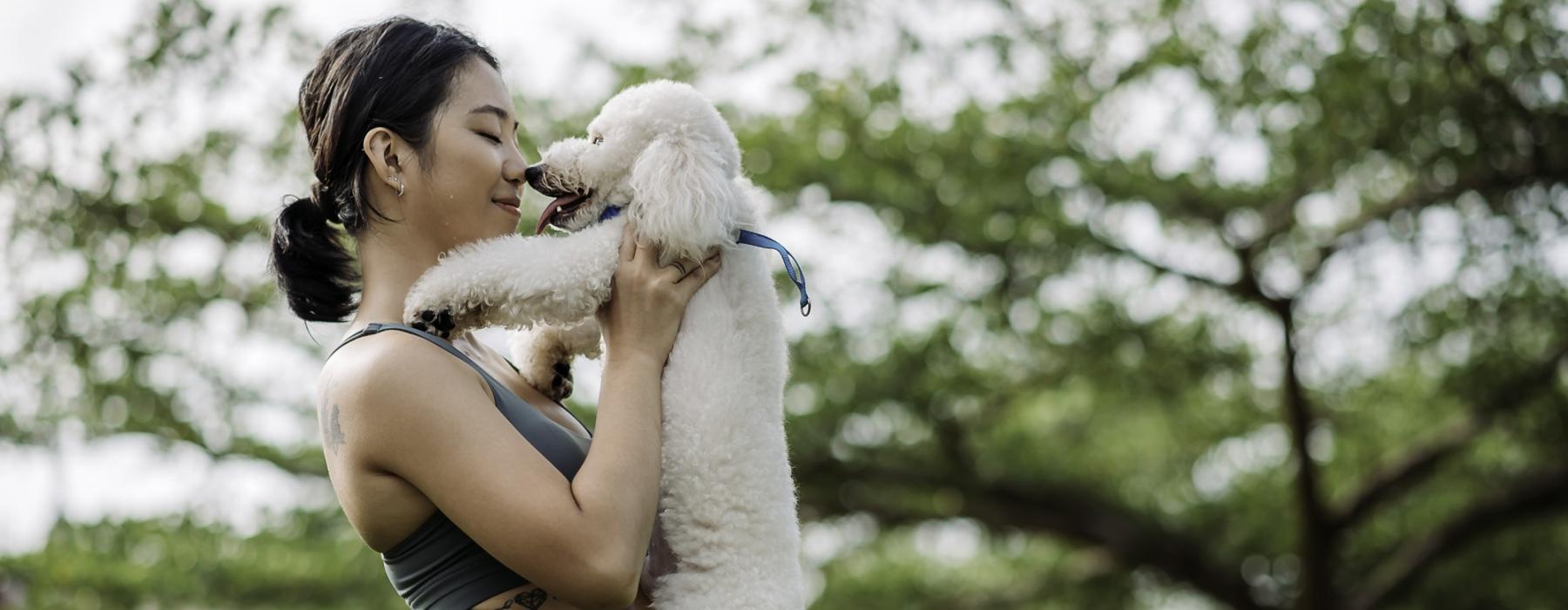 a woman holding a dog