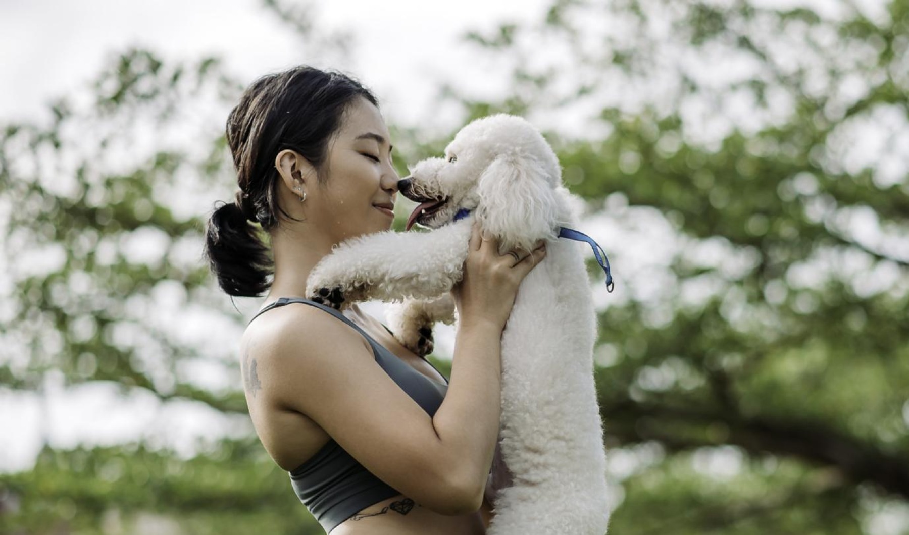 We\'re a pet-friendly community a woman holding a dog