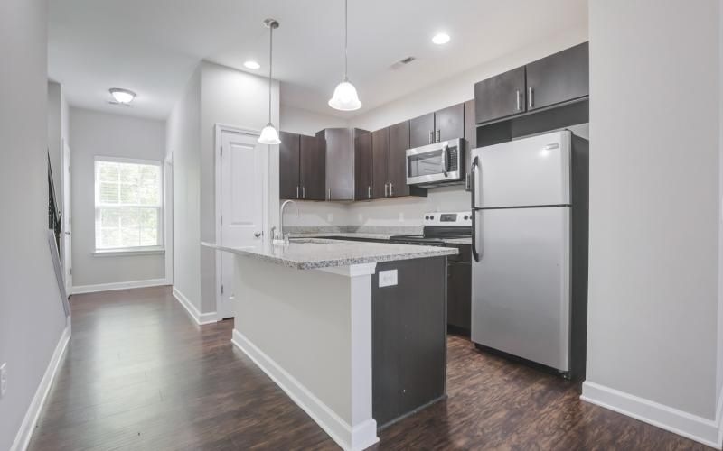 Kitchen with dark cabinets at Charleston Row townhomes with garages for rent in Charleston, NC